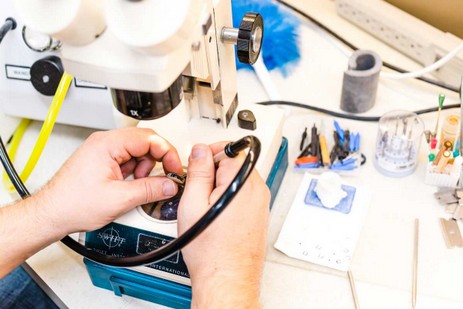 Reparación de Audífonos en Laboratorio Especializado Técnico utilizando herramientas para reparar un audífono en un laboratorio.